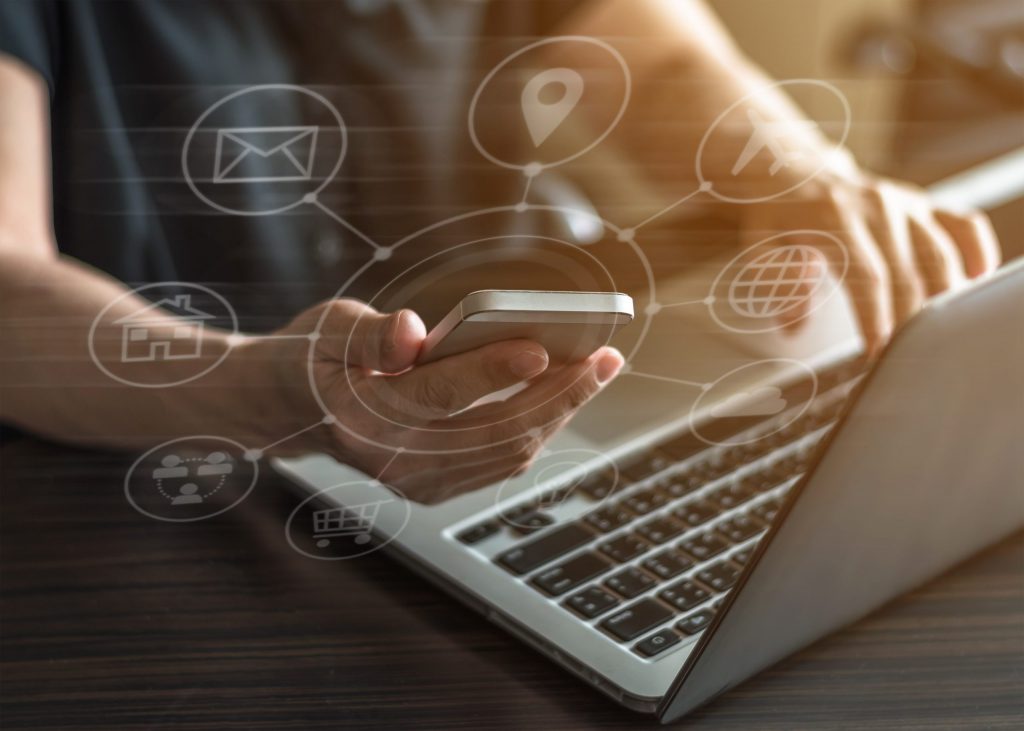 Man Using Phone And Laptop
